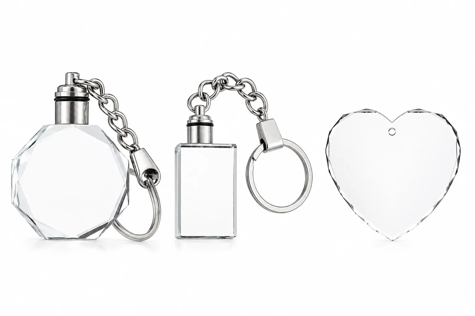 Three crystal keychains with silver metal rings on a white background, including octagon, rectangle, and heart shapes.